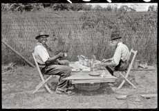 2. Stable hand and trainer eating picnic lunch before the Shelby County Horse Show and Fair. Shelbyville, Shelby County Kentucky, 1940. Farm Security Administration. Marion Post Wolcott