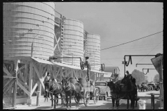 Russell-Lee-Loading-liquid-feed-onto-truck-from-tanks-at-distillery-near-Owensboro-Kentucky-1935