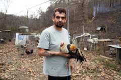 1. Man holding Fighting Cock. Magoffin County Kentucky, 2022. Kentucky Documentary Photographic Project (II).Dane Rhys